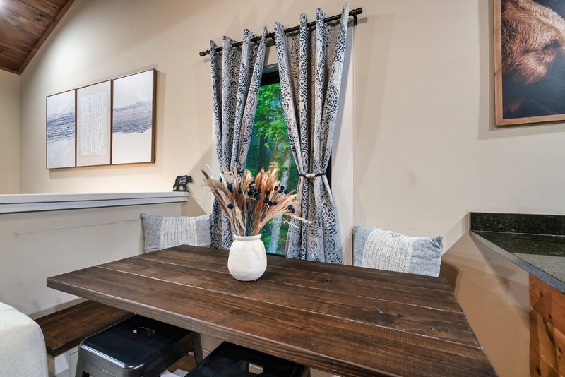 Wooden dining table by the window with bench seating