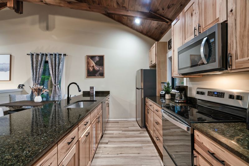 Kitchen counter with a stainless range, microwave and refrigerator and a drip coffee maker