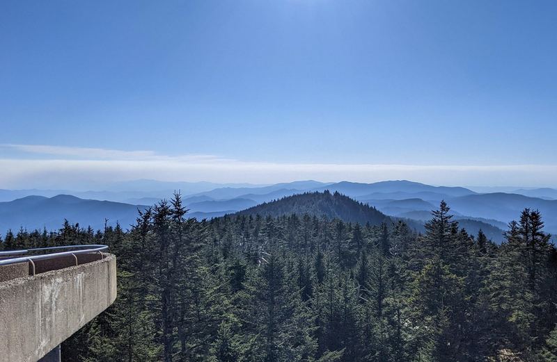 The view from the Kuwohi observation tower ramp over spruce-fir forest to layers of blue mountain ridges
