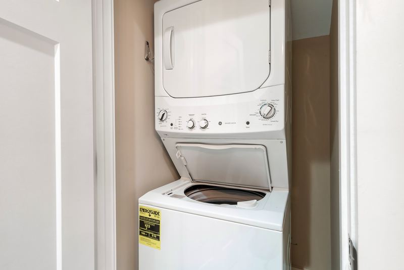 Stacked washer and dryer in the lower-level bathroom